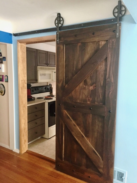 A barn door that personalized the entrance to the kitchen with a rustic ambiance