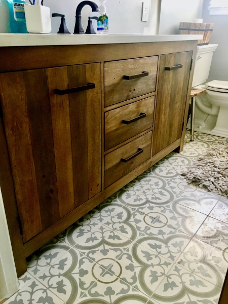Wooden vanity with designer tile for a personalized bathroom instead of the cold and common stark white