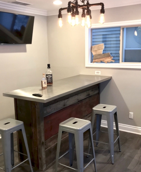 The aluminum top of the bar created the cool contrast to the warm reclaimed wood that it needed