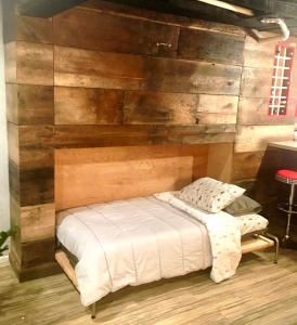 This transformed Fenton reclaimed cottage wood hides fully functional and convenient double Murphy beds