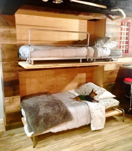 This transformed Fenton reclaimed cottage wood hides fully functional and convenient double Murphy beds