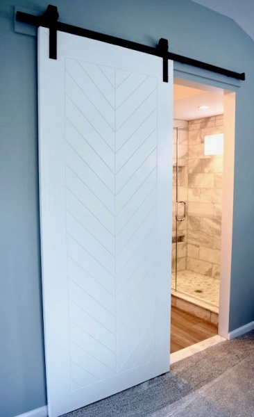 Custom-made bathroom sliding door with chevron print & matte black hardware